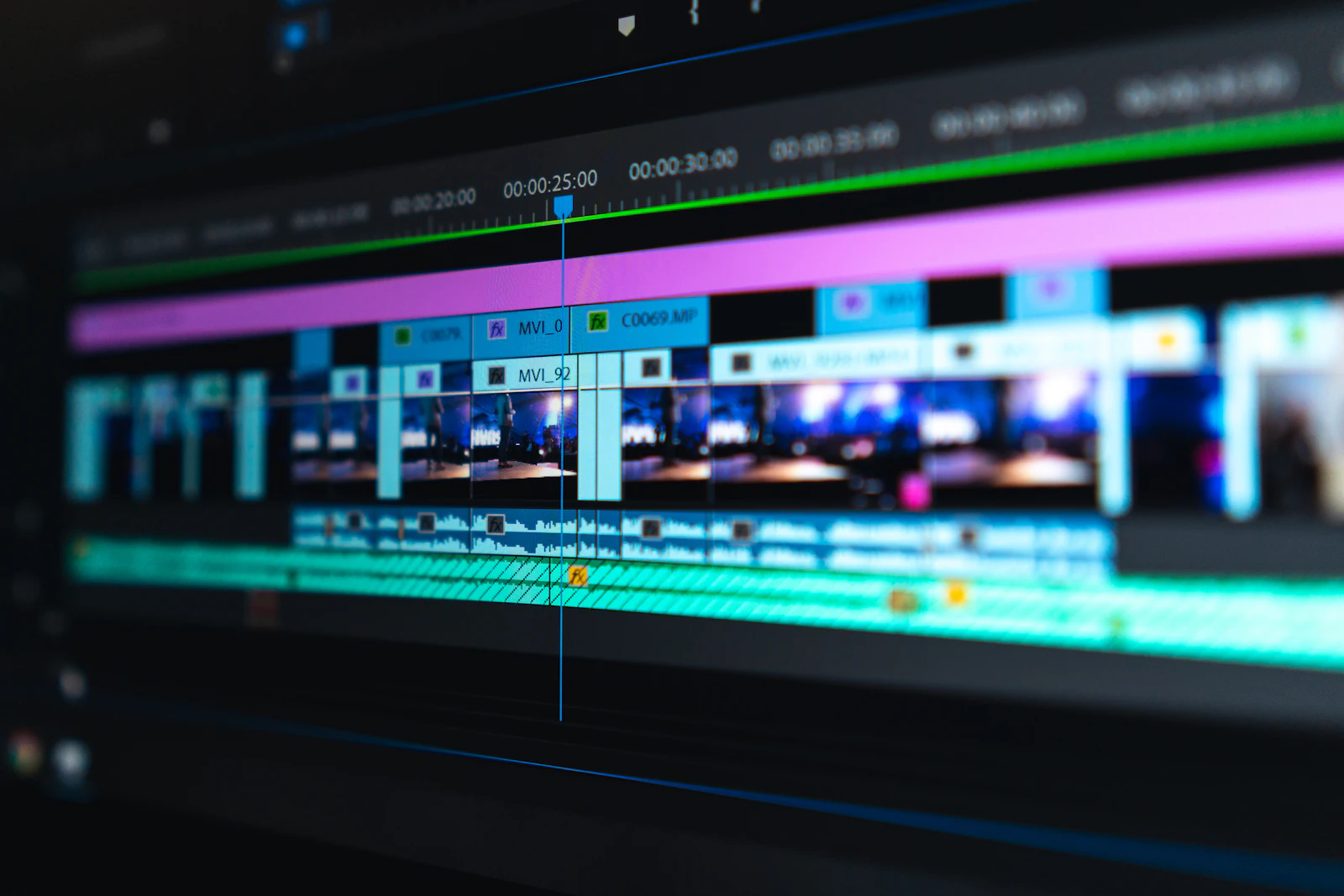 A close-up of an editing timeline: clips, keyframes and a playhead on a monitor.