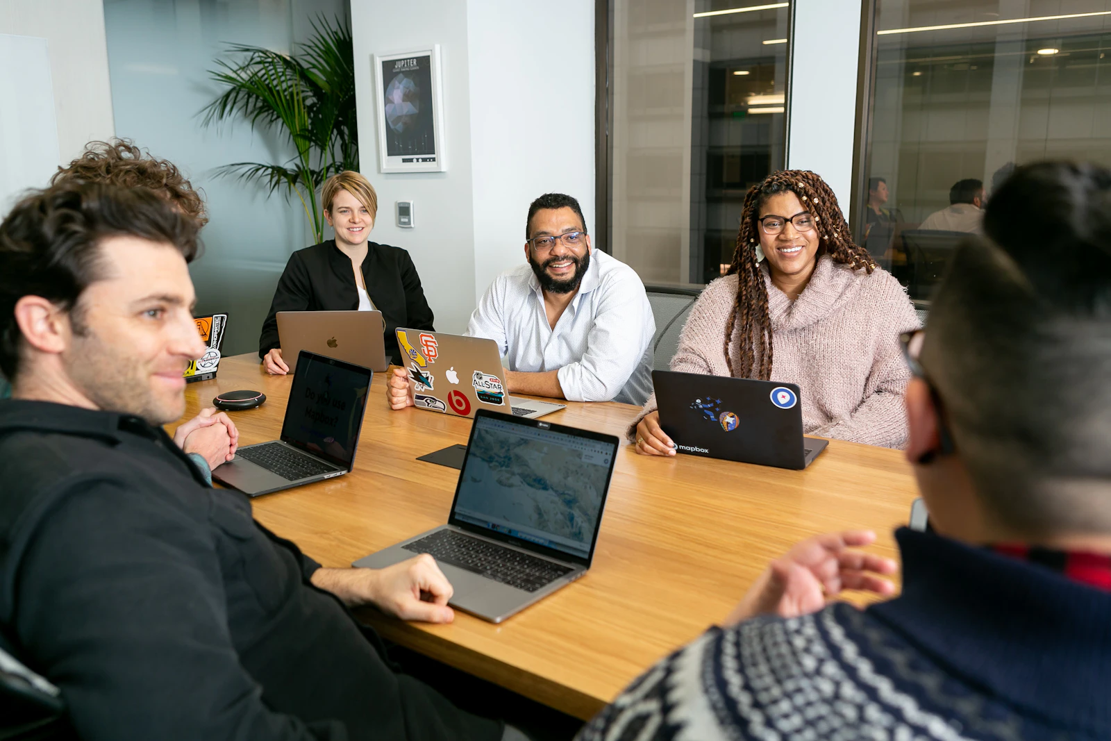 A team working together around a table with laptops